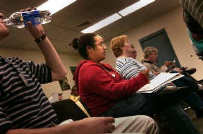 
Mariann Stam, center, listens Thursday as officials talk about insurance regarding families of recently deployed Idaho Guardsman, including her husband, in Post Falls.
 (Brian Plonka / The Spokesman-Review)