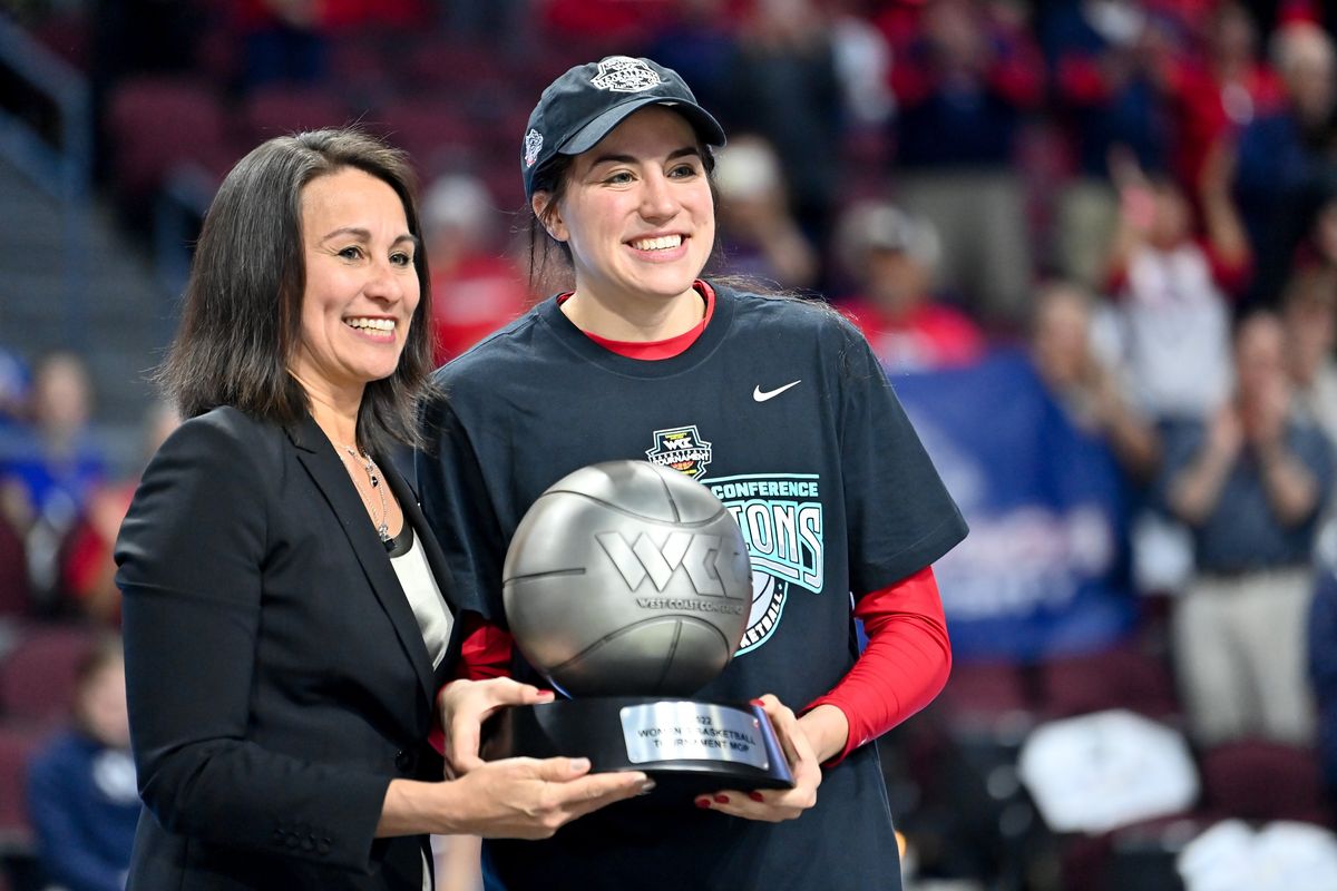 Gonzaga Bulldogs forward Melody Kempton (33) poses for a photo holding the WCC tournament MVP trophy with WCC Commissioner Gloria Nevarez after defeating the BYU Cougars during the second half of the Women’s WCC Championship basketball game on Tuesday Mar 8, 2022, at the Orleans in Las Vegas, Nev. Gonzaga won the game 71-59. (Tyler Tjomsland/The Spokesman-Review)