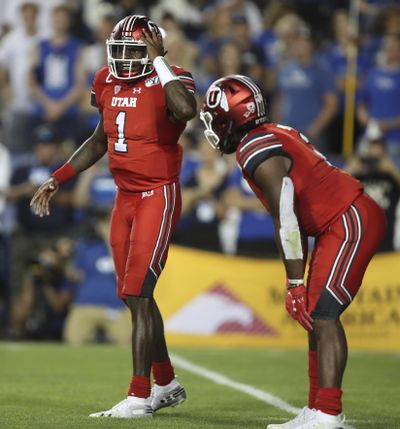 Utah quarterback Tyler Huntley (1) calls a play with Utah running back Zack Moss (2) in the backfield in the second half during an NCAA college football game against BYU, Thursday, Aug. 29, 2019, in Provo, Utah. (George Frey / AP)