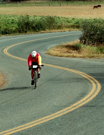 Barb Brucker of Seattle bikes along West Hauser Lake Road in Post Falls during the Tour des Lacs two-day ride in September.