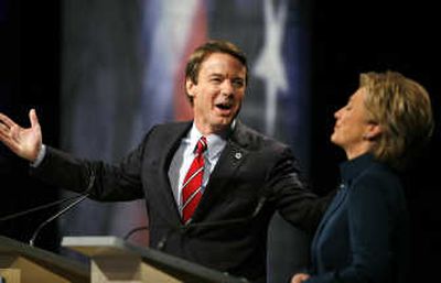 
Former Sen. John Edwards, D-N.C.,  and Sen. Hillary Rodham Clinton, D-N.Y., share a light moment during the Democratic  debate in Johnston, Iowa, on Thursday. Associated Press
 (Associated Press / The Spokesman-Review)
