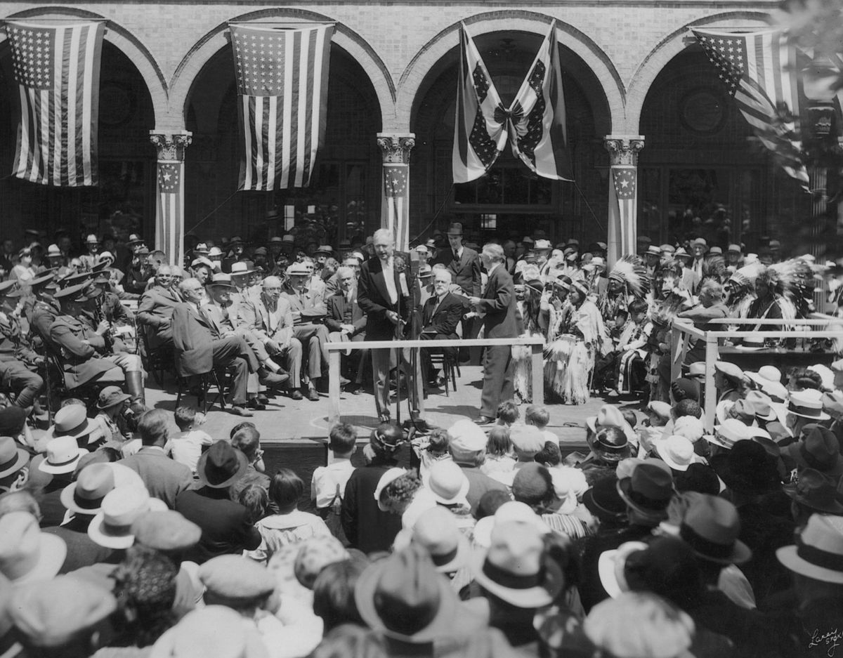 June 18, 1934: Fred K. Jones, president of the Spokane Chamber of Commerce in 1933 and 1934, presides over the opening of bids for the construction of the Grand Coulee Dam in front of the Chamber of Commerce building on Riverside Avenue.