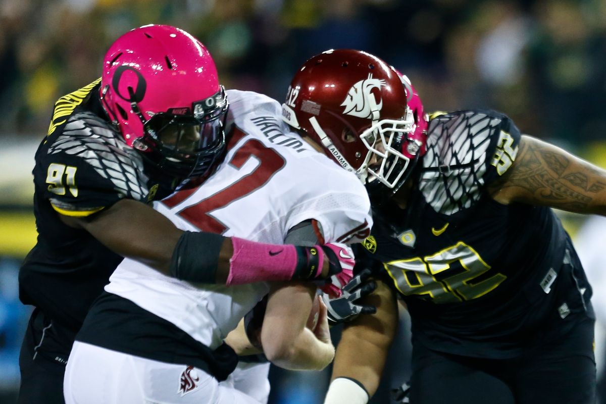 Oregon DE Tony Washington, left, sacks WSU QB Connor Halliday. Washington had 2 of the Ducks’ 4 sacks of Halliday on Saturday. (Associated Press)