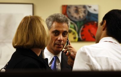 Rep. Rahm Emanuel, D-Ill., center, talks on his cell phone before leaving his congressional office  in Chicago Thursday night.  (Associated Press / The Spokesman-Review)
