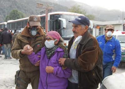 
Residents wear masks as they evacuate the village of Futaleufu in a remote stretch of Chilean Patagonia on Tuesday. Associated Press photos
 (Associated Press photos / The Spokesman-Review)