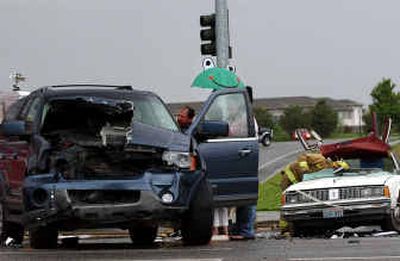 
Lt. Terry Odom speaks with the driver of the SUV that collided with an Oldsmobile at the intersection of Liberty Lake Road and Country Vista Drive in Liberty Lake.
 (Liz Kishimoto / The Spokesman-Review)