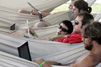 
Unidentified participants of What the Hack use their laptops while they lie in hammocks at a camping ground in Liempde, the Netherlands, on Thursday. About 3,000 hackers, privacy advocates and other cyber-activists gathered for the three-day What the Hack, a self-styled computer-security conference dealing with such issues as digital passports, biometrics and cryptography.
 (Associated Press / The Spokesman-Review)