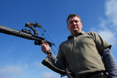 Devon Romney, a machinist who owns Romney Motion in Otis Orchards, developed the Airow Gun, a device that mounts to a bow, enabling an archer to shoot paintballs or pellets.  (Rich Landers / The Spokesman-Review)