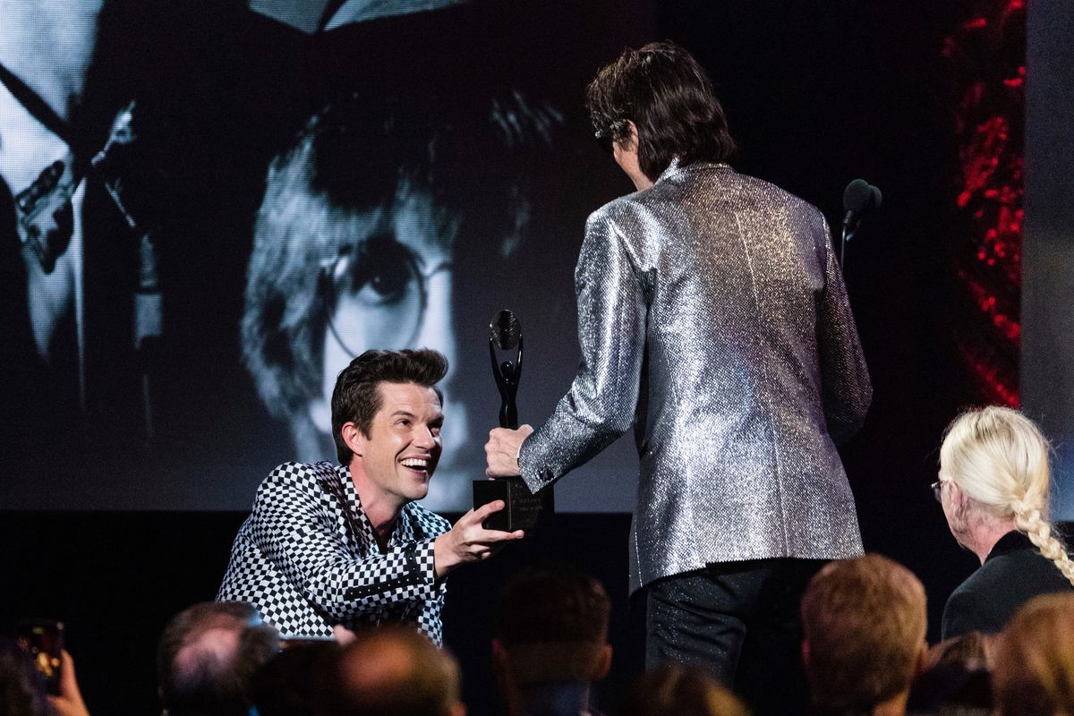 The Killers frontman Brandon Flowers, left, and the Cars frontman Ric Ocasek are seen at the 2018 Rock and Roll Hall of Fame Induction Ceremony at Cleveland Public Auditorium on April 14, 2018, in Cleveland, Ohio. The Killers were one of Jillian Condran’s first music clients as a young publicist.  (Michael Zorn/Invision/AP)