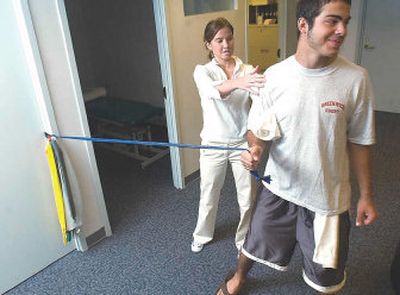 
Frank Gianchetta, 17, right, a football and rugby player, works with physical therapist Jen Straehle to rehabilitate his injured shoulder.
 (The Stamford Advocate / The Spokesman-Review)