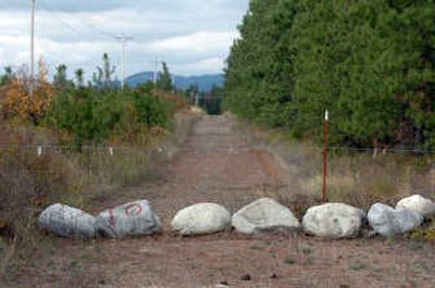 
On rural Sheep Springs Road outside Athol, some residents have blocked it off with boulders and barbed wire.  
 (Jesse Tinsley / The Spokesman-Review)