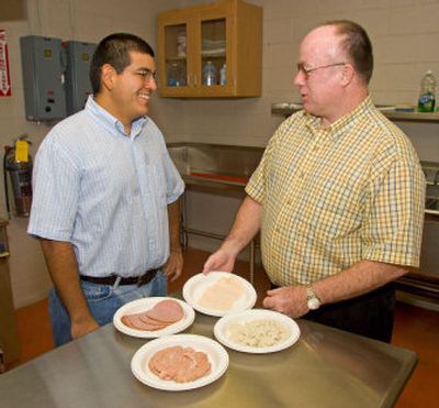 
Professor of Poultry Science Daniel Fletcher, right, discusses the process of turning poultry dark meat into a white meat product with graduate student Roger Huezo on Aug. 8. 
 (University of Georgia / The Spokesman-Review)