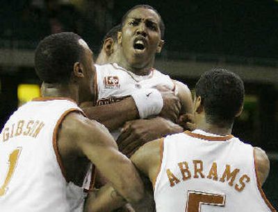
Texas guard Kenton Paulino, center, is lifted by his teammates. 
 (Associated Press / The Spokesman-Review)