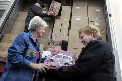 Janelle Kortlever, left, and Judy Thies check on a shipment of toys with Bill Kuch for distribution at the Christmas Bureau.   (CHRISTOPHER ANDERSON / The Spokesman-Review)