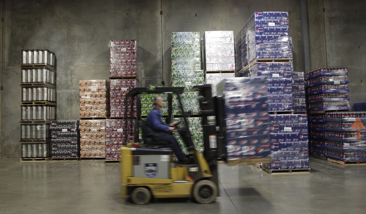 Randy Monroe moves a pallet of soda at Harbor Pacific Bottling’s  distribution center in Elma, Wash.  (Associated Press)