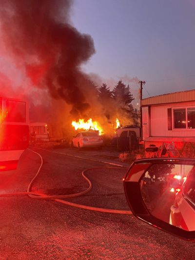 A 5th-wheel trailer in the Pinecroft Mobile Home Park in Spokane Valley is engulfed in flames Tuesday night. One occupant was severely burned.  (Photo courtesy of the Spokane Valley Fire Department)
