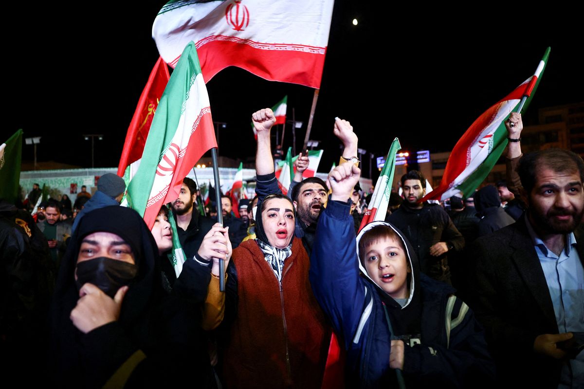 People wave flags as they gather after a two-week ceasefire in the Iran war was announced on Wednesday in Tehran, Iran.   (Reuters )