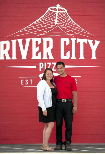 Jacqueline and Phillip Barnard of River City Pizza stand in front of their soon-to-open second location at 17018 E. Sprague Ave. on August 14, 2019. (Kathy Plonka / The Spokesman-Review)