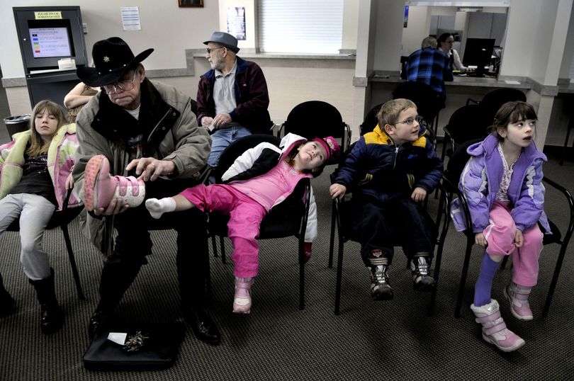 Chuck Young along with his great-grandchildren, from left Keira, Macaylee, Brayden and Destiny wait at the Social Security office in Coeur d'Alene on March 13, 2009 in order to obtain the proper documents for an Idaho Identification card. KATHY PLONKA The Spokesman-Review (Kathy Plonka / The Spokesman-Review)