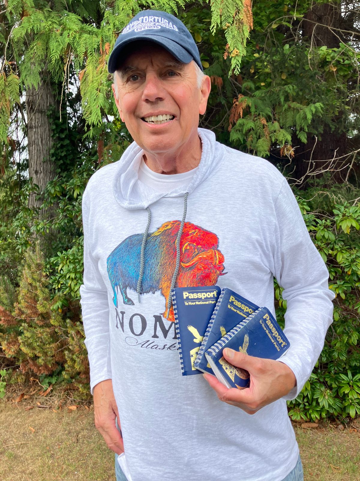 Garland Frankfurth holds the National Parks passports he’s filled with stamps from more than 400 National Park Service sites.  (Courtesy of Garland Frankfurth)