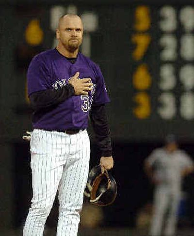 
Colorado's Larry Walker acknowledges the crowd after doubling for his 2,000th career hit.
 (Associated Press / The Spokesman-Review)