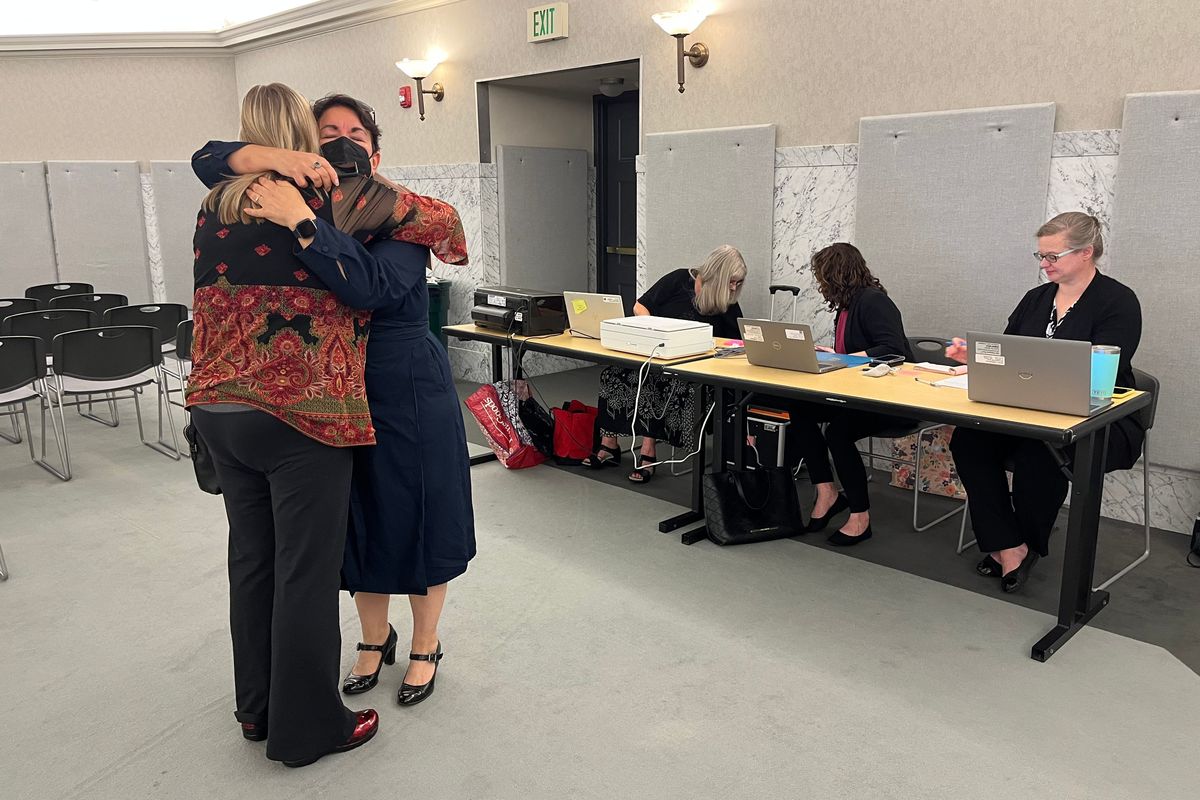 Mothers Sarah Bain and Randi Abrams-Caras embrace before receiving birth certificates for their children who were stillborn. Bain and Abrams-Caras helped lead a fight in the Legislature to pass a bill that allows families to receive birth certificates for stillborn babies.  (Laurel Demkovich / The Spokesman-Review)