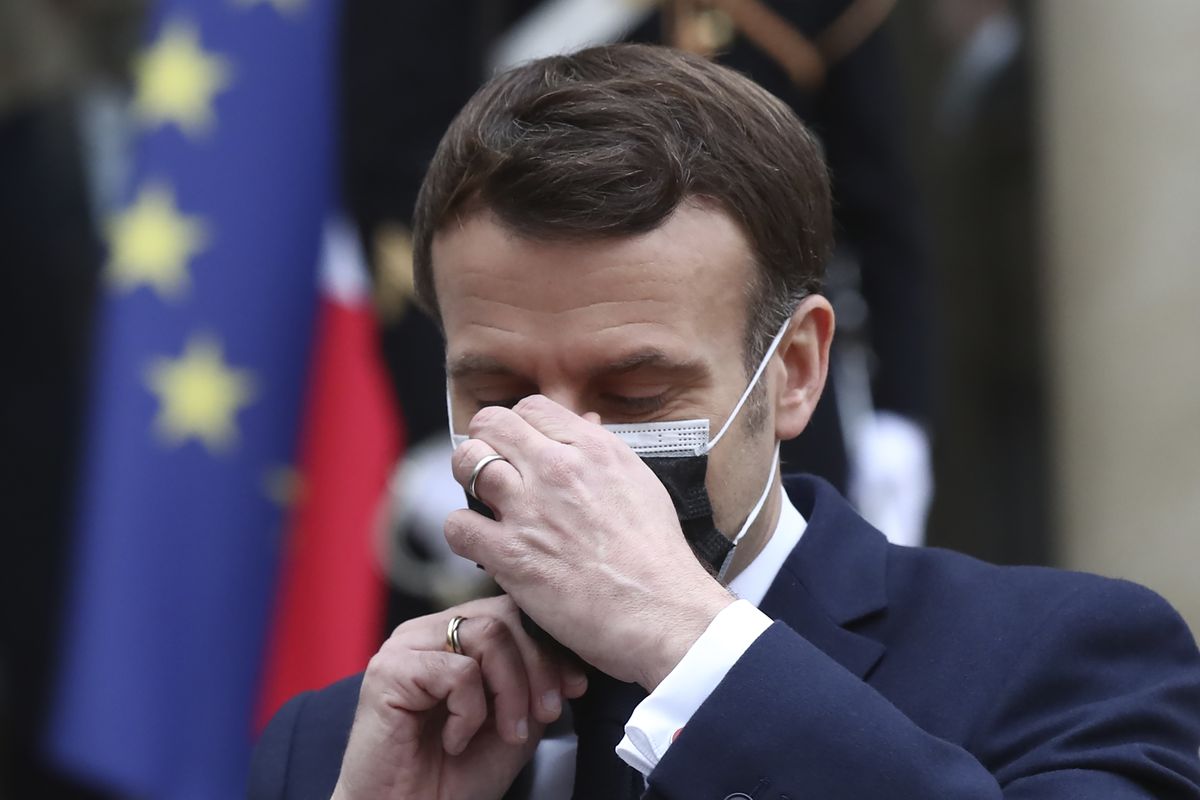 French President Emmanuel Macron takes off his face mask as he welcomes Serbian President Aleksandar Vucic for a working lunch at the Elysee Palace in Paris, Monday, Feb. 1, 2021. Serbian President Aleksandar Vucic is in Paris for bilateral talks with French President Emmanuel Macron.  (Michel Euler)