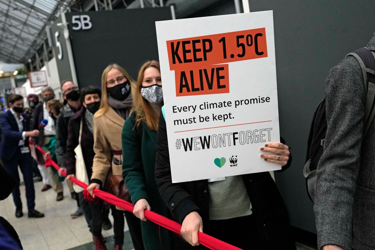 Climate activists hold a demonstration through the venue of the COP26 U.N. Climate Summit in Glasgow, Scotland, Friday, Nov. 12, 2021. Negotiators from almost 200 nations were making a fresh push Friday to reach agreements on a series of key issues that would allow them to call this year