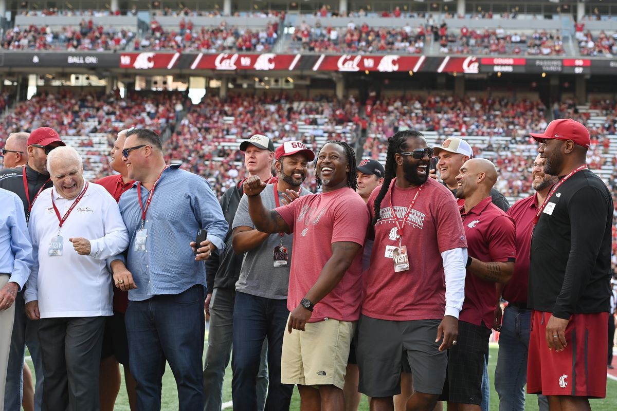 Washington State’s 1997 Rose Bowl players and coaches pose for a photo on Gesa Field during Saturday’s homecoming game in Pullman.  (Tyler Tjomsland/The Spokesman-Review)