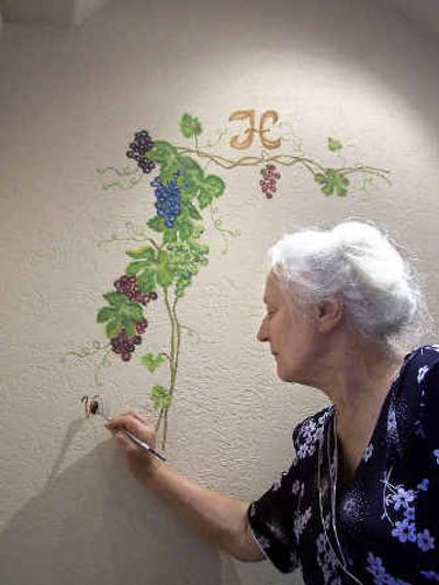 Valentina Korenovskaya, an immigrant and artist from Kyrgyzstan, signs the work she completed in the North Idaho home of Harry and Ann Holmberg.Valentina Korenovskaya, an immigrant and artist from Kyrgyzstan, signs the work she completed in the North Idaho home of Harry and Ann Holmberg.
 (Rebecca Nappi/Rebecca Nappi/ / The Spokesman-Review)