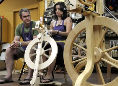 Travis Romine and Sara Garber, who help run family-owned Paradise Fibers, spin merino wool, soy silk and glitz fibers on a Lendrum spinning wheel in the instruction area of their store.danp@spokesman.com (Dan Pelle / The Spokesman-Review)
