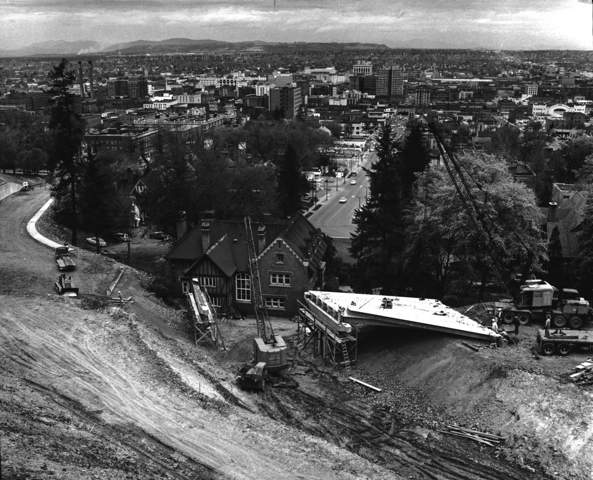 1963: The 1896 Charles Sweeny-Francis Finucane home, designed with Tudor-style features by architect Kirtland Cutter, stood directly in the path of the downhill route of a new connector from Bernard Street to Washington Street, which was part of a $950,000 project to create a new route up the South Hill. The route would ease traffic congestion on nearby Grand Boulevard and keep vehicles off Monroe Street during icier conditions.  (Spokesman-Review Photo Archives)