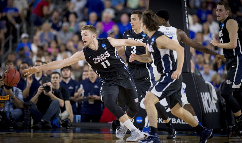 Gonzaga’s Domantas Sabonis reaches for loose ball during the first half of Sunday’s Elite Eight game in Houston. Sabonis scored seven of his nine points in the half (Colin Mulvany)