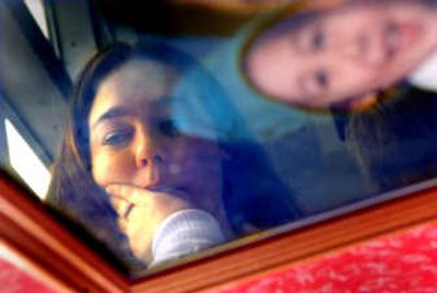 
Holly Cork, seen here Friday, is reflected in a photograph of her son Angelo,  who was removed from her custody shortly after the photo was taken some eight years ago. Angelo, now 10, is in the care of foster parents in Montana while Cork battles in the court system to get her son back in Spokane. 
 (Brian Plonka / The Spokesman-Review)