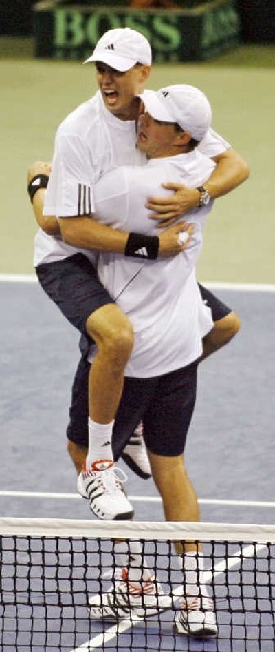 
Mike Bryan of the victorious U.S. Davis Cup team jumps into the arms of his brother, Bob. Associated Press
 (Associated Press / The Spokesman-Review)