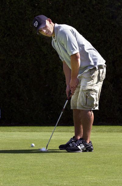 
EVHS senior Josh White lines up a putt at the Liberty Lake Golf Course. White finished 15th at the State 3A high school golf tournament.
 (Liz Kishimoto / The Spokesman-Review)