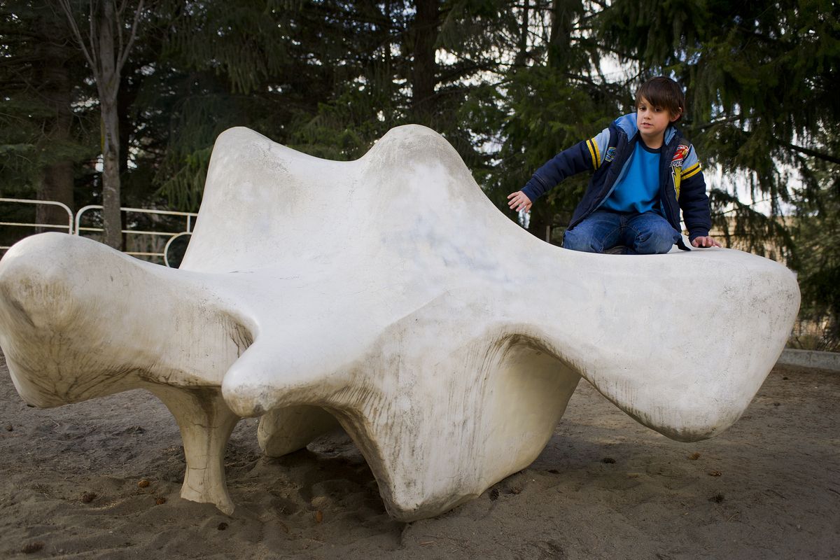 Jagger Black, age 7, of Moses Lake, plays on the sculpture crafted by Charles W. Smith in Riverfront Park on April 6. The Spokane Parks and Recreation Department plans to remove the sculpture because it has developed cracks and is considered unsafe. (Colin Mulvany / The Spokesman-Review)