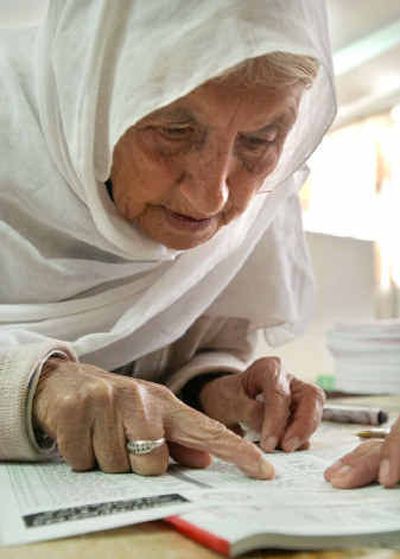 
An elderly Palestinian woman looks for her name on a voter list during municipal elections Thursday in the West Bank town of Jericho.An elderly Palestinian woman looks for her name on a voter list during municipal elections Thursday in the West Bank town of Jericho.
 (Associated PressAssociated Press / The Spokesman-Review)