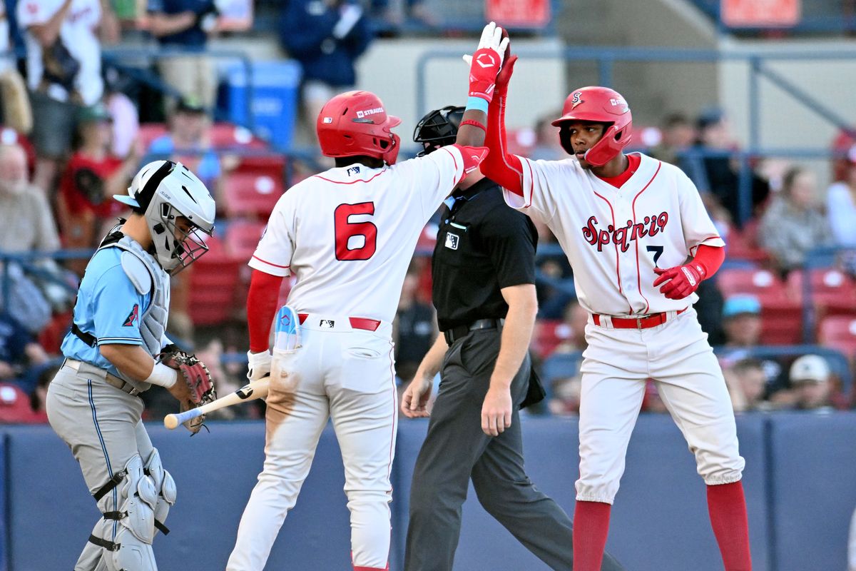 Spokane Indians infielder Roynier Hernandez (6) greets Kelvin Hidalgo after he scored on a balk in the third inning against the Hillsboro Hops on June 2, 2026 at Avista Stadium.  (James Snook)