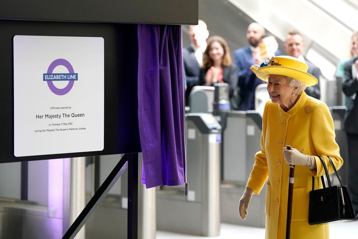 Britain’s Queen Elizabeth II unveils a plaque to mark the Elizabeth line’s official opening at Paddington station in London on Tuesday during the completion of London’s Crossrail project.  (Andrew Matthews)