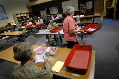 
Election workers open ballots Monday that will be counted today for Spokane's primary election. 
 (Brian Plonka / The Spokesman-Review)