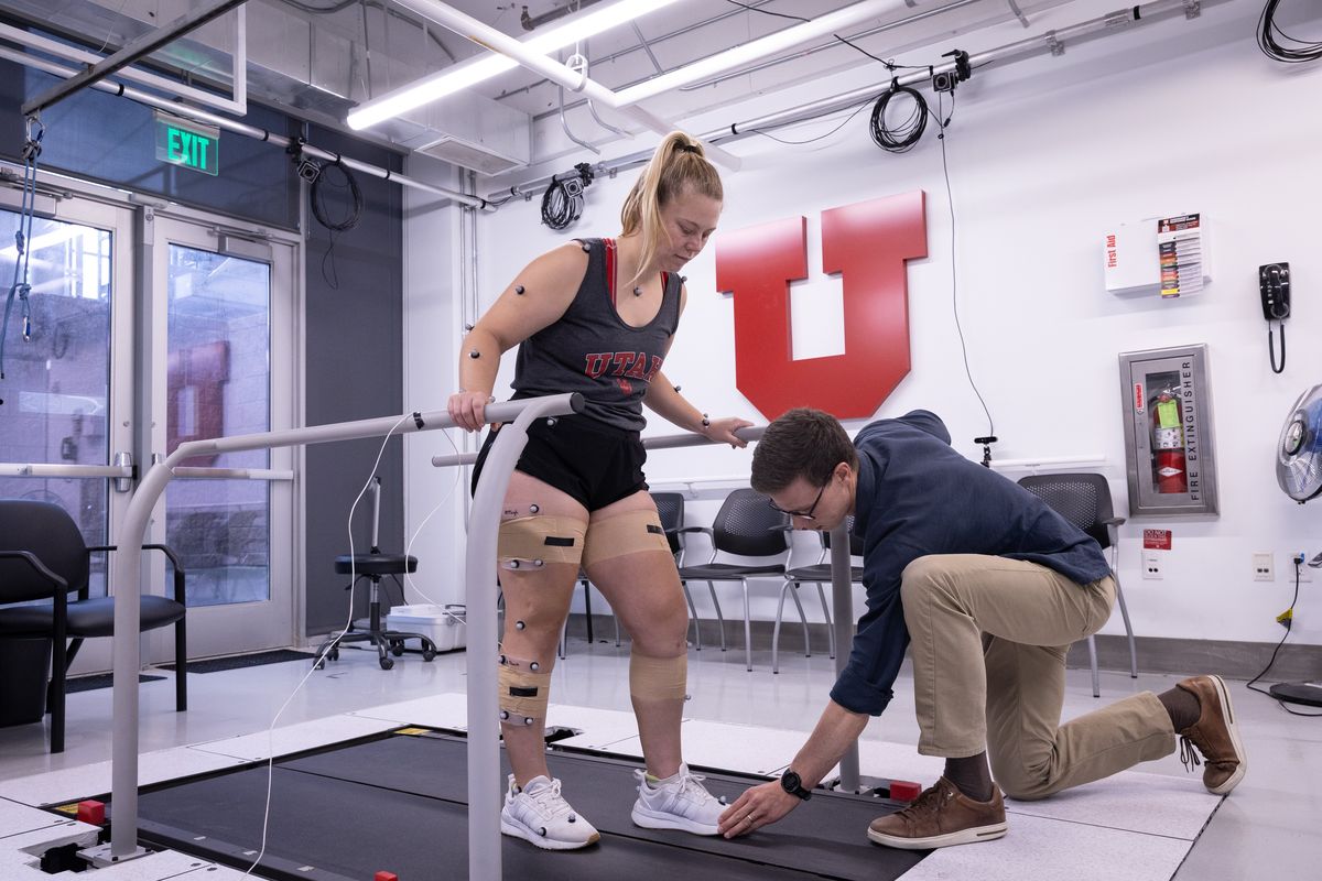 Scott Uhlrich, right, instructs Emily Miller on how to change her walking pattern when she receives biofeedback.  (Dan Hixson/University of Utah)
