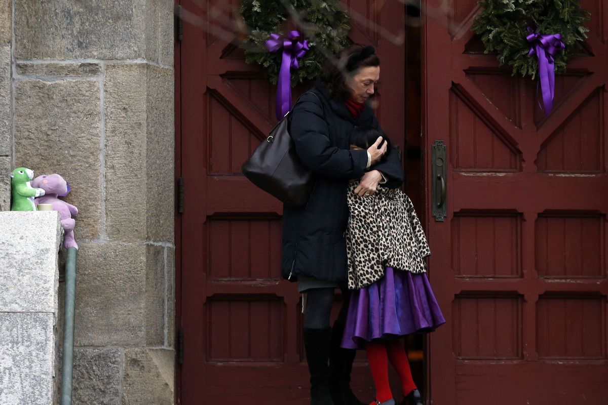 A woman hugs a young girl as they arrive for services at Trinity Church, Sunday, Dec. 16, 2012 in Newtown, Conn.  A gunman walked into Sandy Hook Elementary School in Newtown Friday and opened fire, killing 26 people, including 20 children. (Jason Decrow / Fr103966 Ap)