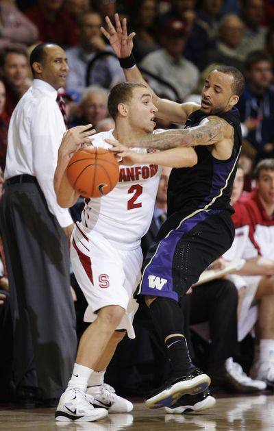 Washington guard Venoy Overton, right, attempts a second-half steal against Stanford’s Aaron Bright.  (Associated Press)