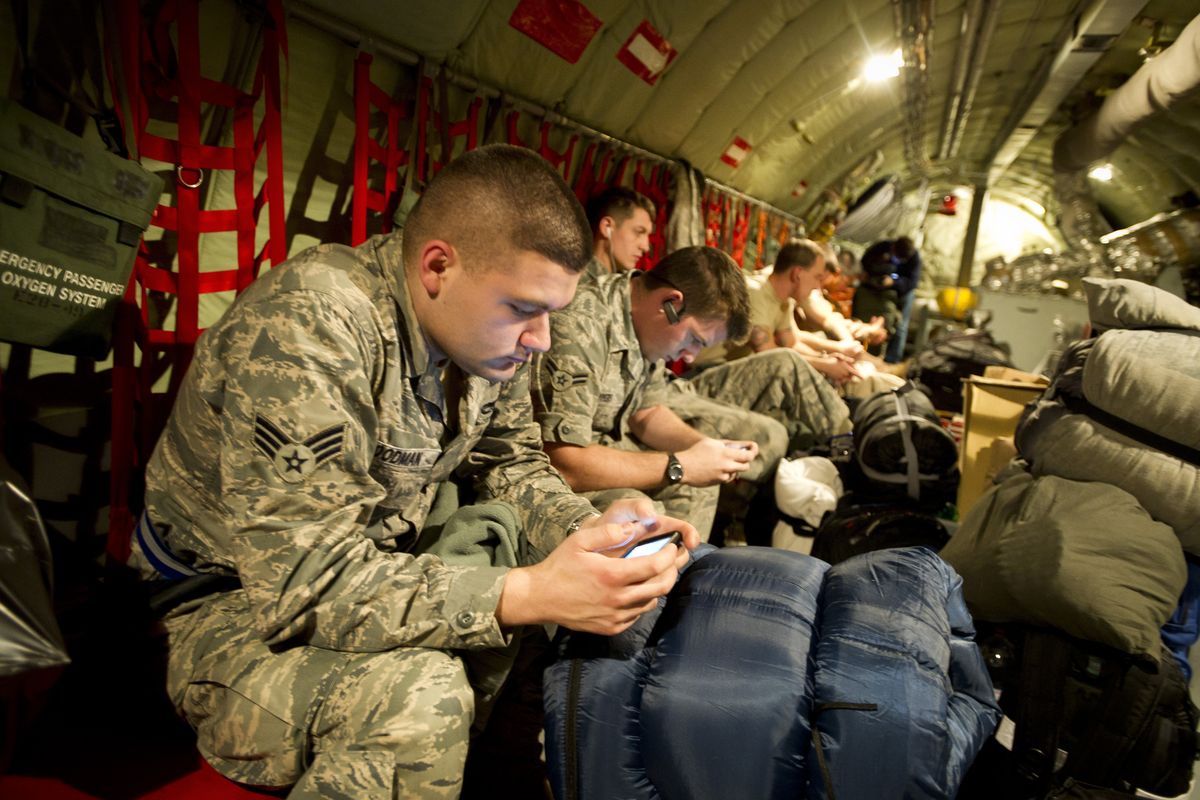 From left to right, Daniel Goodman, senior airman, and Josh Myers and Antonio Rapp, both airmen 1st class, sit aboard a KC-135R Stratotanker flight form Fairchild Air Force Base to Kyrgyzstan, where they