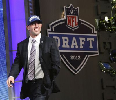 No surprise here as Andrew Luck walks on stage after being made the first pick in the draft by Indianapolis. (Associated Press)