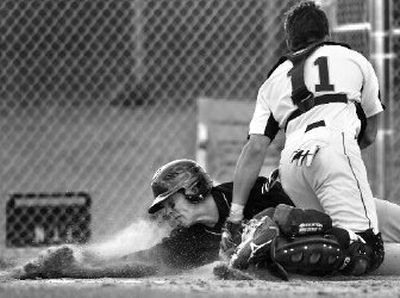 
Mead's Sean McNaghten tags out University's Ben Borgman at the plate during Thursday's game. 
 (Jed Conklin / The Spokesman-Review)
