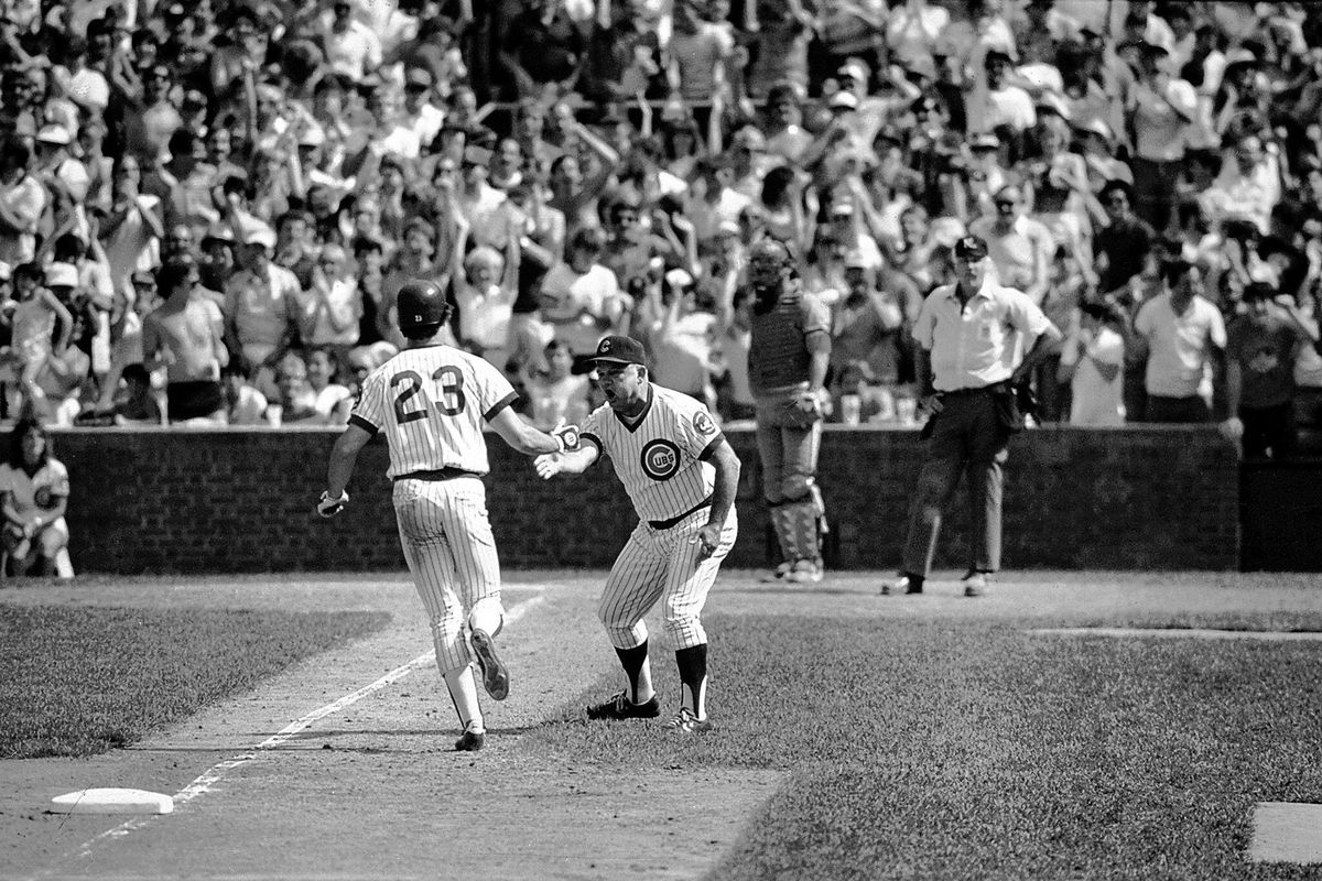 Chicago Cubs second baseman Ryne Sandberg is congratulated by third-base coach Don Zimmer after hitting a ninth-inning home run against the Cardinals on June 23, 1984.  (Tribune News Service)