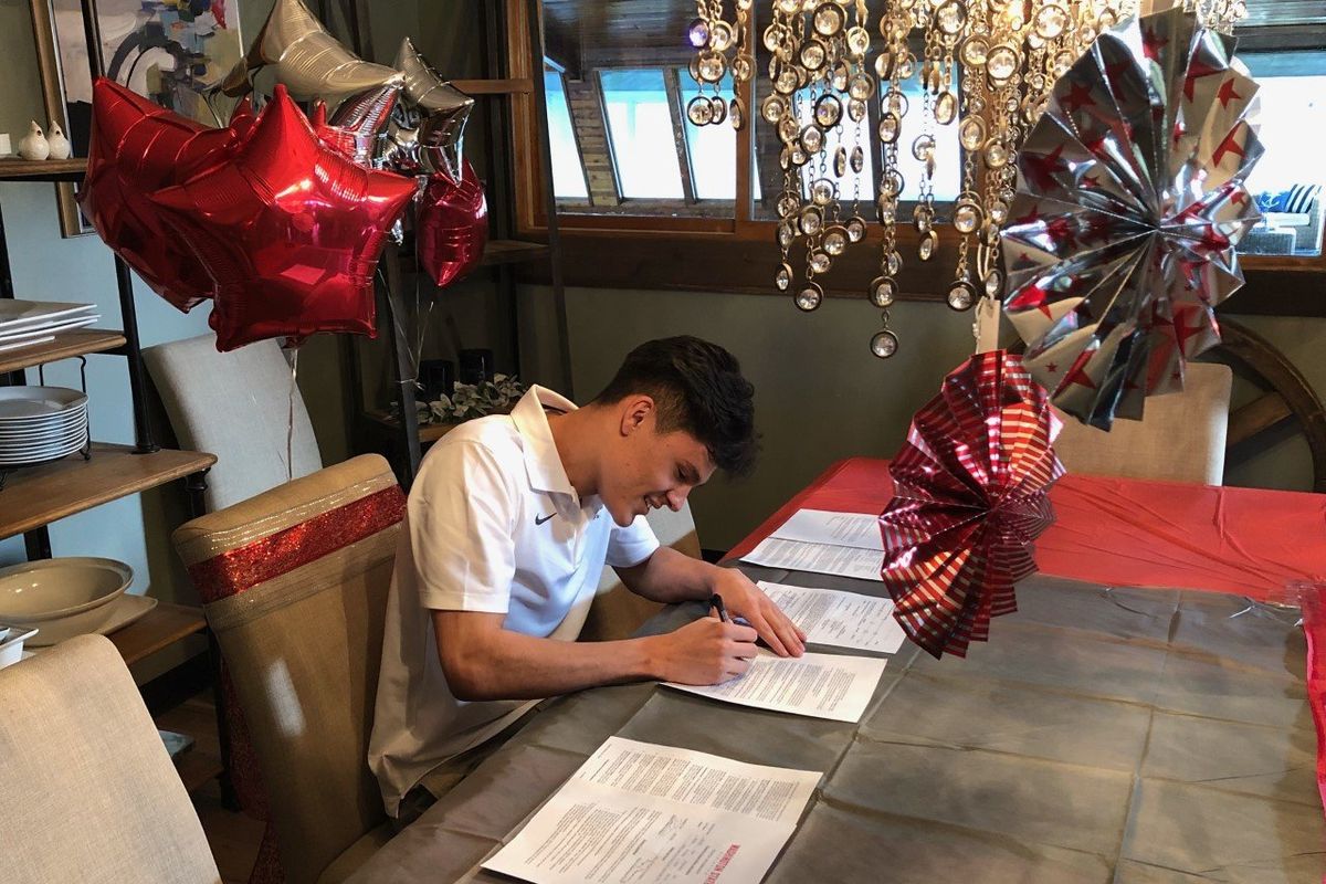 Dylan Darling signs a National Letter of Intent at his home Wednesday to play basketball at Washington State.  (Dave Nichols)