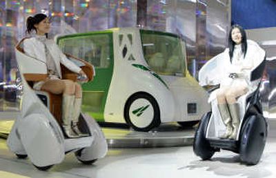 
Models drive Toyota Motor Corp.'s concept single-seat vehicle i-Real past their concept car RiN.  Associated Press
 (Associated Press / The Spokesman-Review)